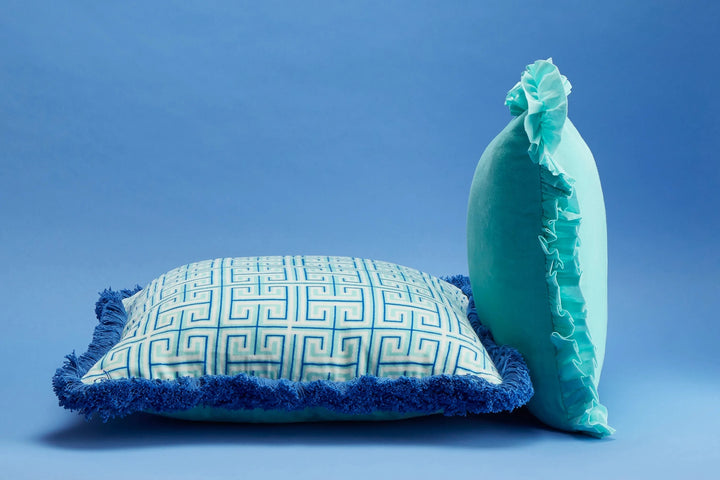 Maison Splendid printed velvet cushion shown with aqua velvet frill cushion