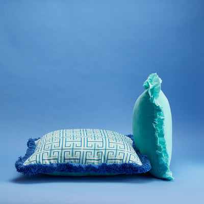 Maison Splendid printed velvet cushion shown with aqua velvet frill cushion