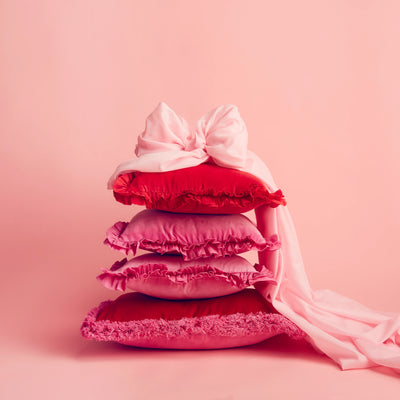 Maison Splendid selection of velvet frill cushions in pink and red with bow